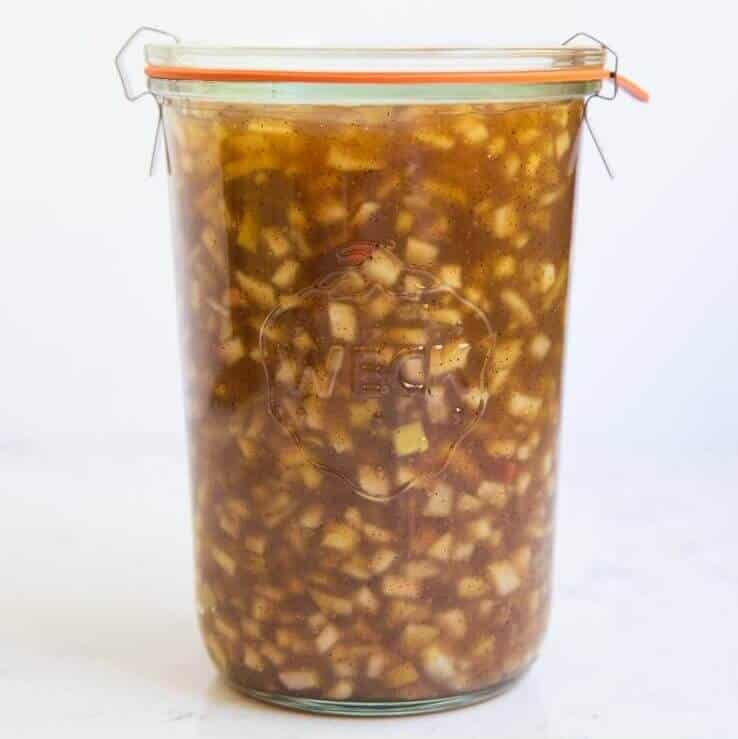 Apple pie filling in a glass container.