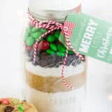M&M cookie mix layered in a mason jar with a christmas tag