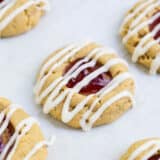 peanut butter and jelly thumbprint cookie drizzled with vanilla glaze