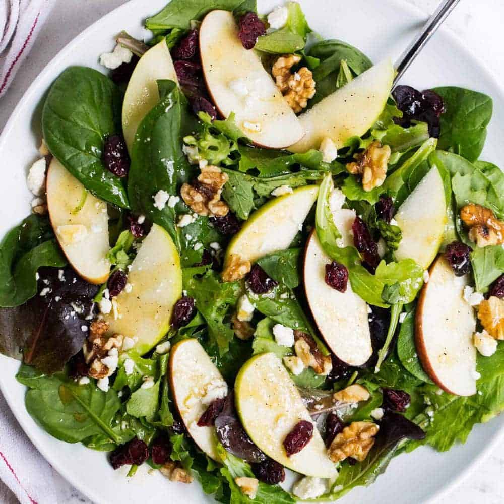 Spinach salad on a white plate. 