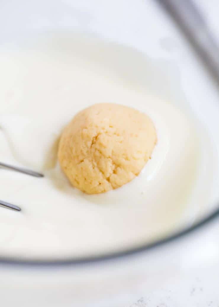 dipping sugar cookie truffle in white chocolate 