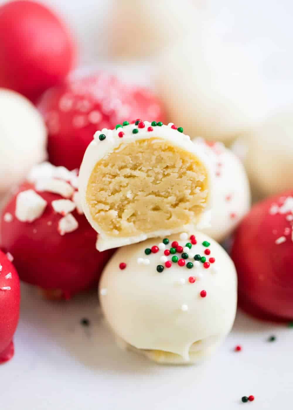 A close up of a half eaten Christmas sugar cookie truffle.