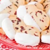 cranberry orange shortbread cookies on a red plate