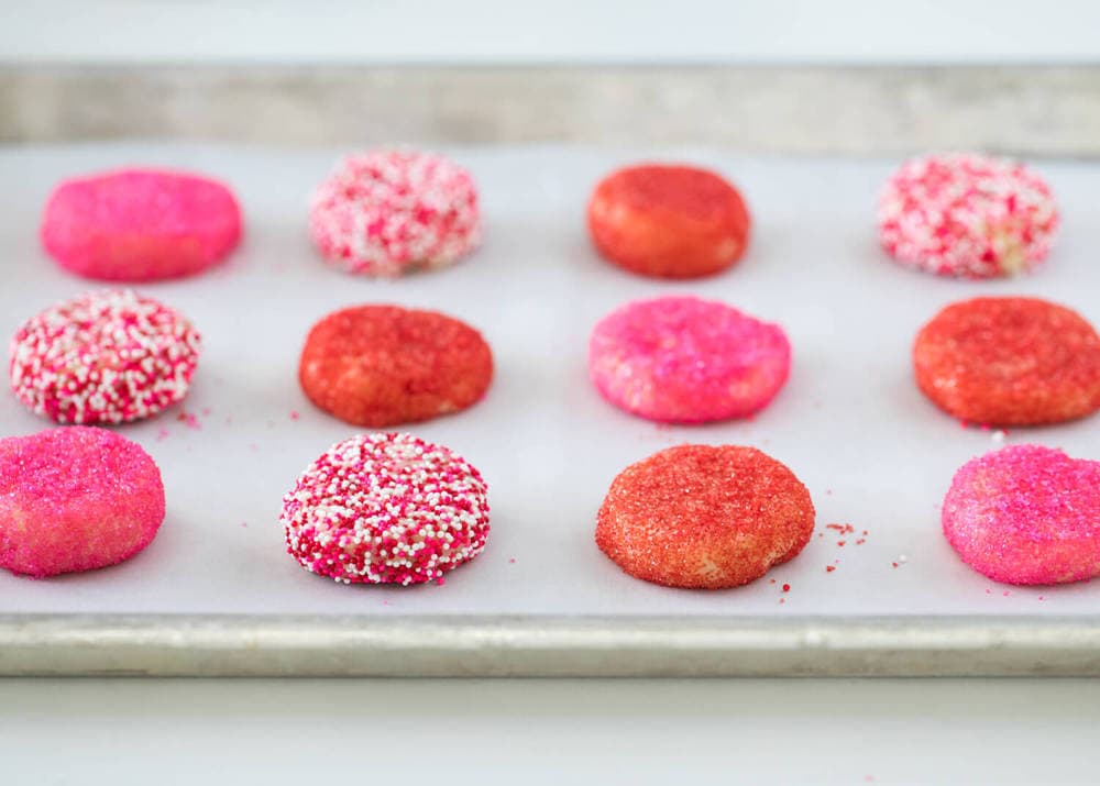 decorated valentine sugar cookies on a baking sheet 