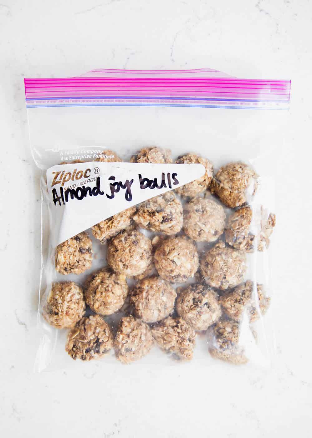 Labeled freezer bag filled with energy bites.