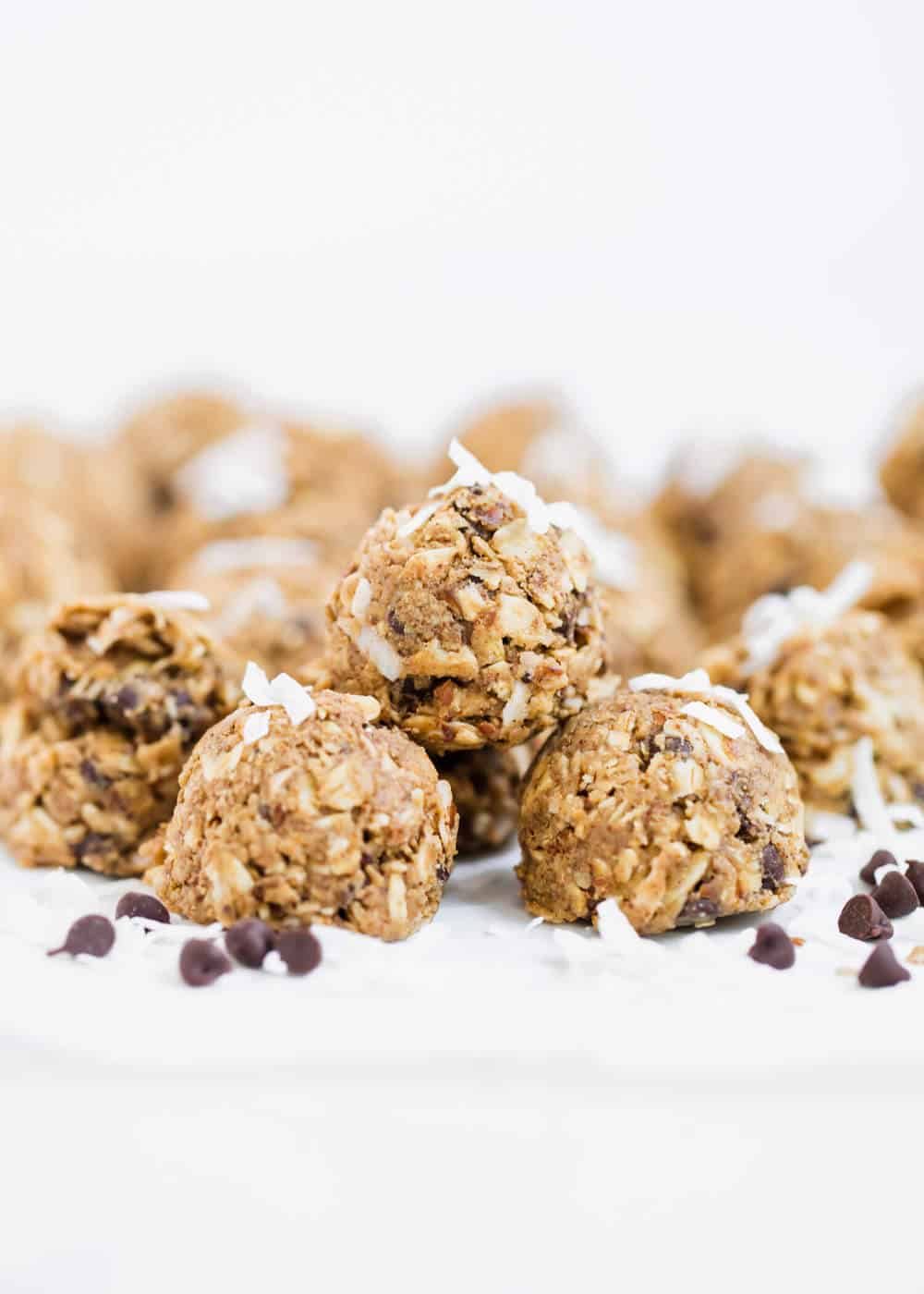 Almond joy energy bites topped with shredded coconut and chocolate chips.