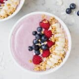 smoothie bowl topped with fresh fruit and granola