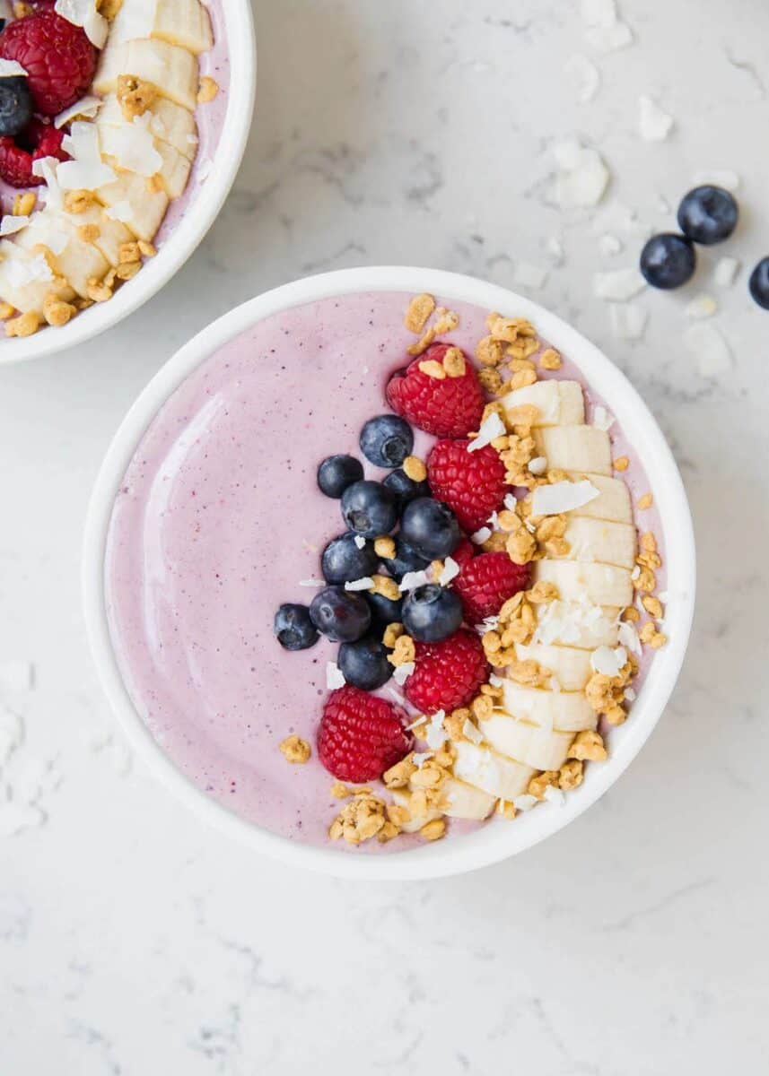 smoothie bowl topped with fruit and granola