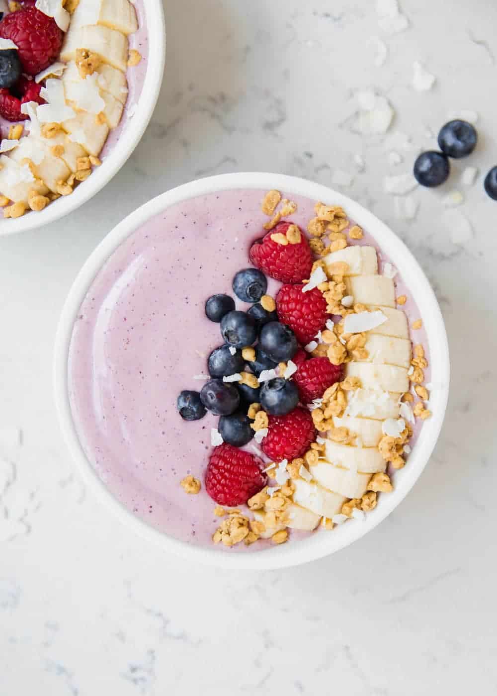 Smoothie bowl topped with fruit and granola.