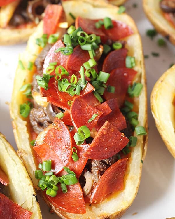 close up of a potato skin with pizza toppings 