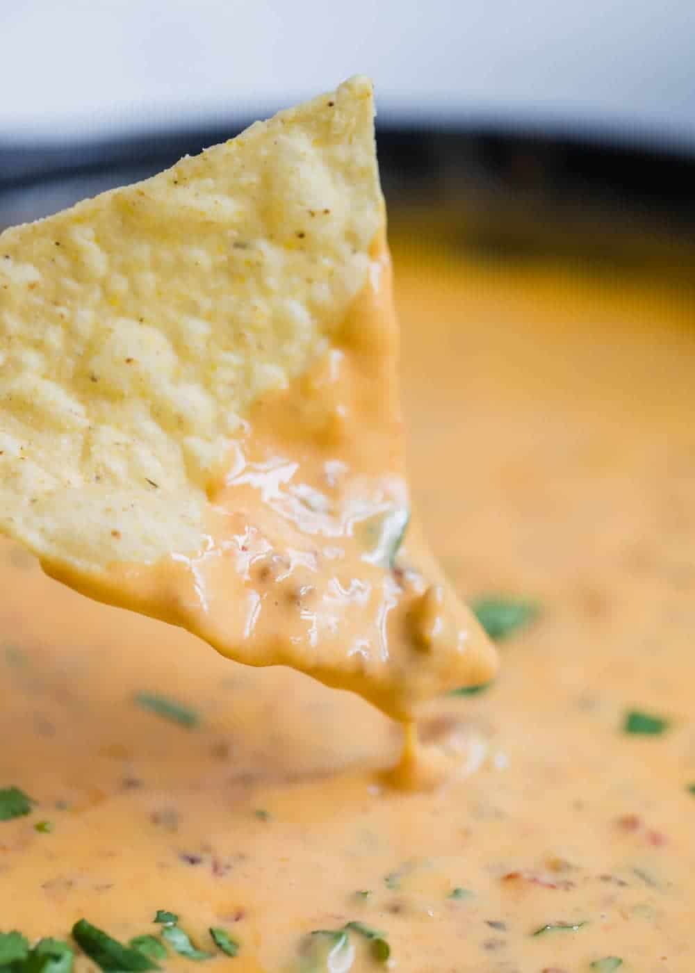 Dipping a chip into chorizo queso dip. 