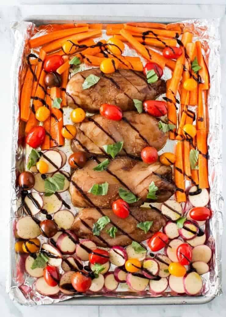 balsamic chicken and veggies on a baking sheet 