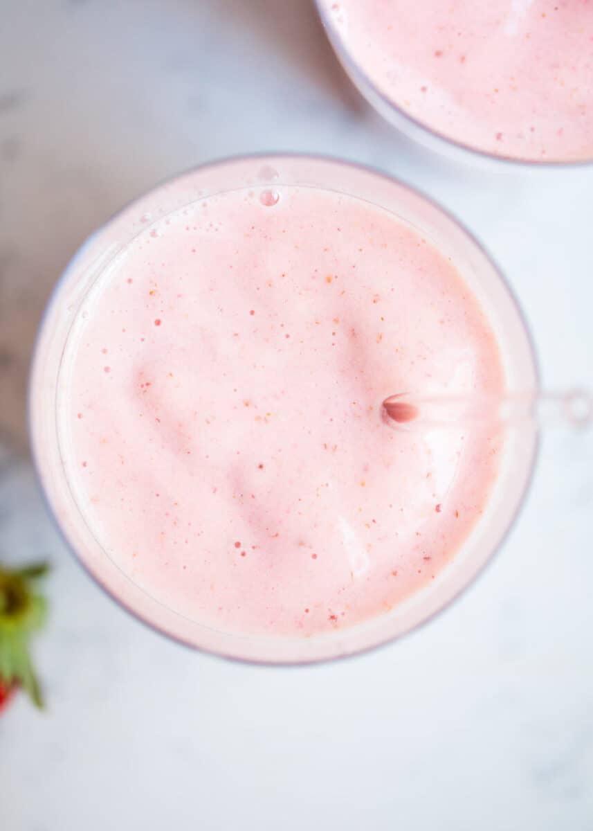 close up of strawberry banana smoothie in glass 