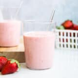 strawberry banana smoothie in a glass with a straw