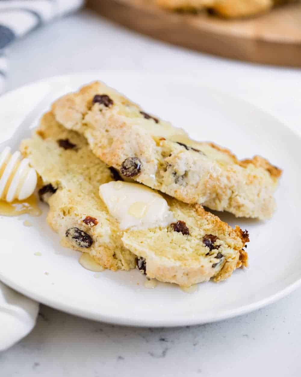 Irish soda bread with raisins that's topped with butter and honey.