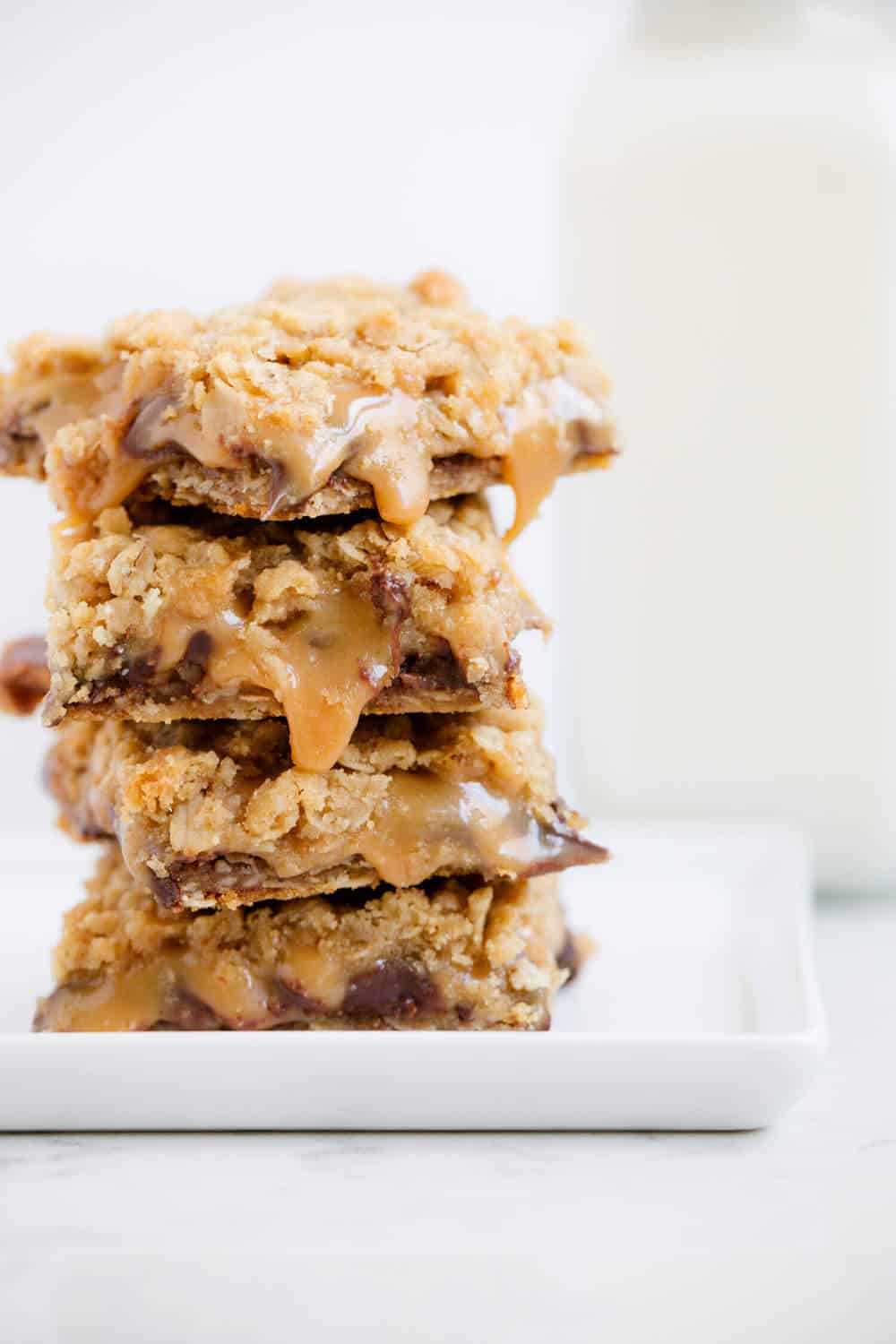 Stack of gooey oatmeal carmelitas.