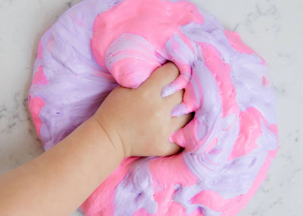 Squishing fluffy slime with hands.