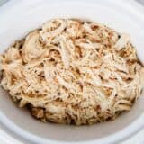 shredded chicken in a white crock pot