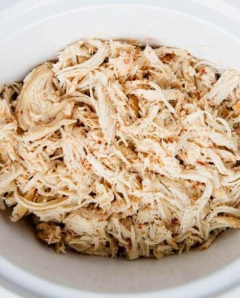 shredded chicken in a white crock pot