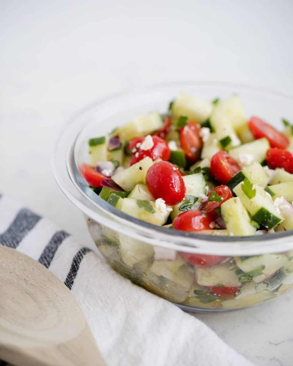 cucumber tomato salad in a glass bowl