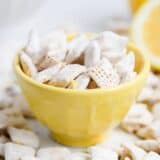 lemon muddy buddies in a yellow bowl