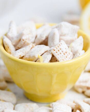 lemon muddy buddies in a yellow bowl