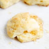 Easy homemade biscuit sliced open showing fluffy interior with butter and honey.