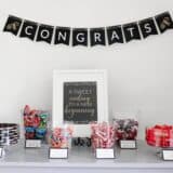 a graduation party table with bowls of candy