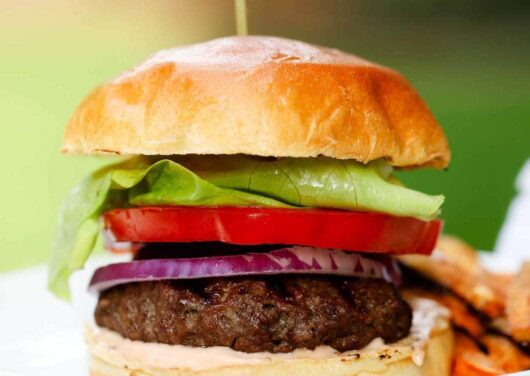 a close up of a hamburger on a plate