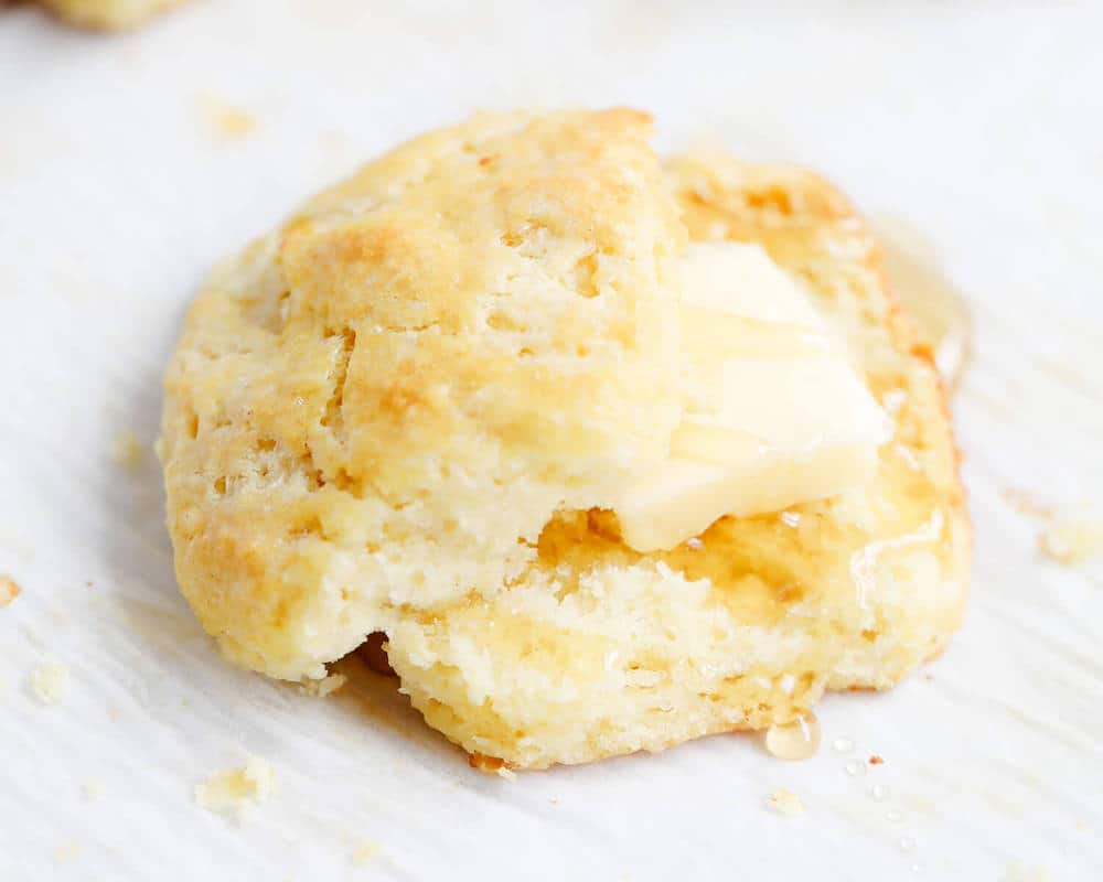 Homemade biscuit with butter and honey.