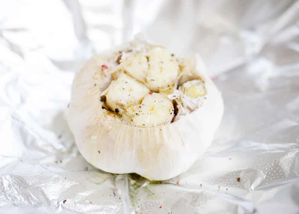 Garlic clove on aluminum foil.