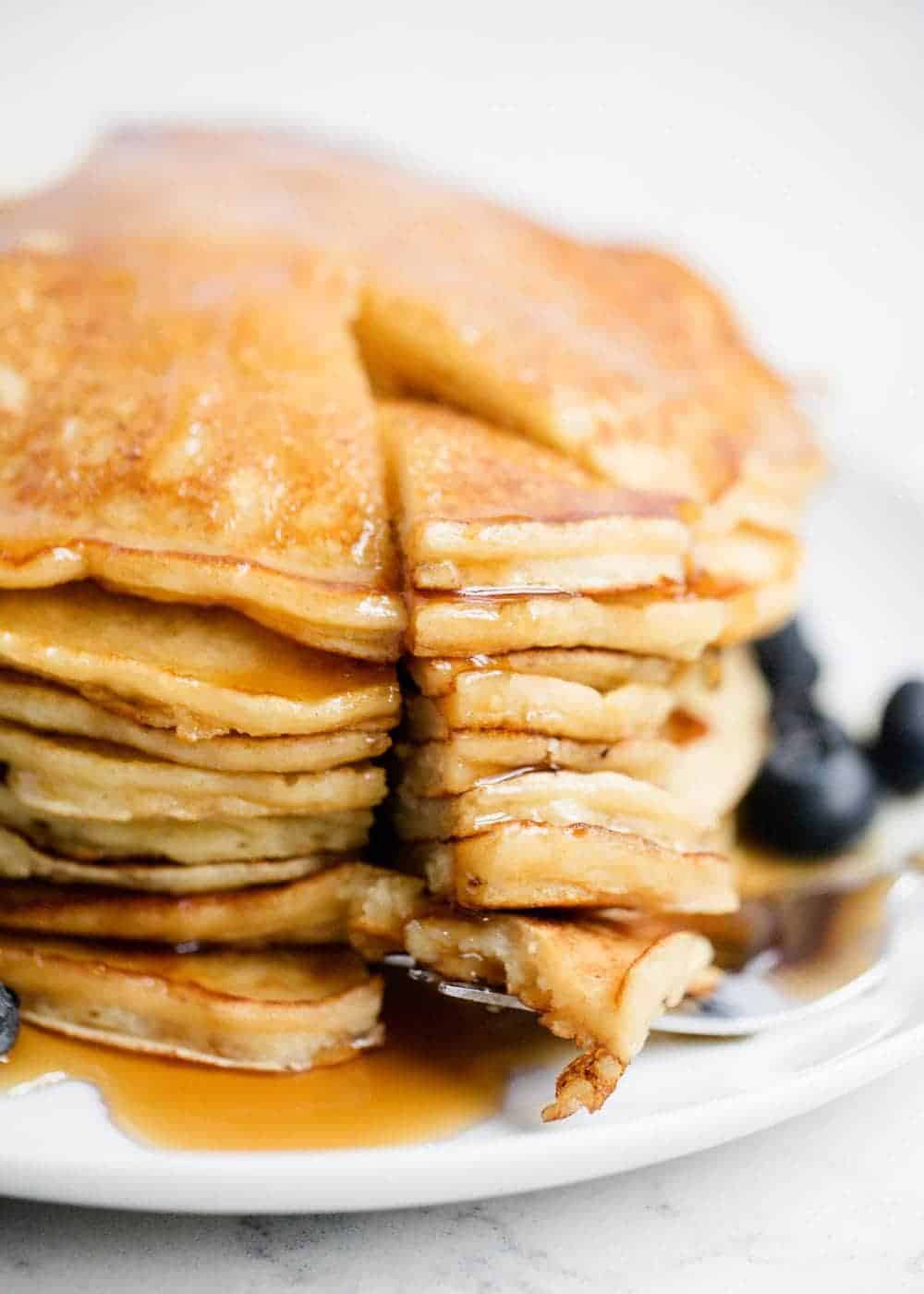 Stack of ricotta pancakes with maple syrup.