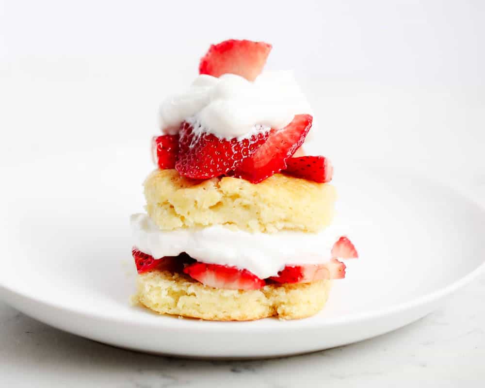 Strawberry shortcake biscuit on a white plate.