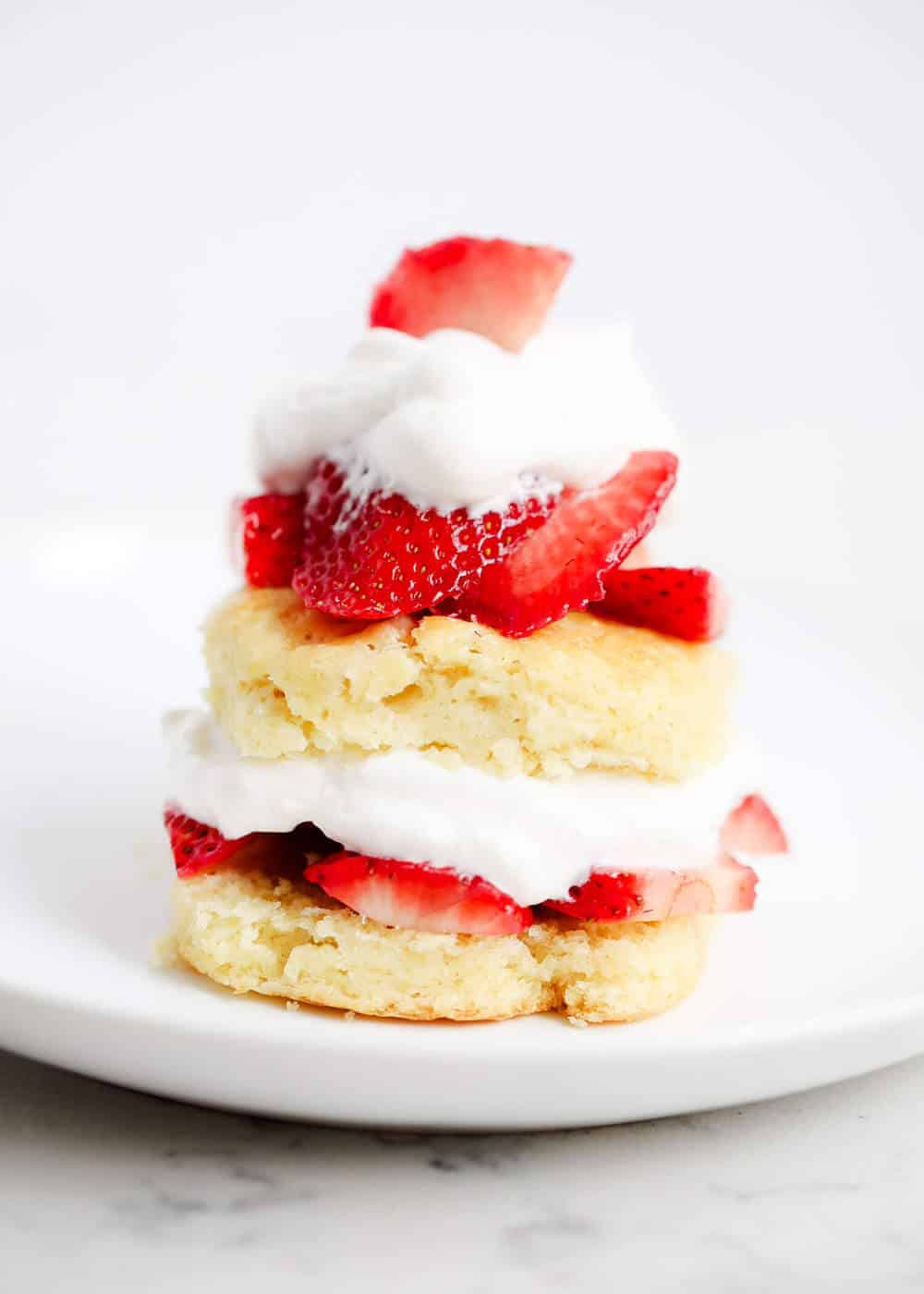 Strawberry shortcake biscuit on white plate.