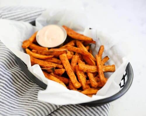 sweet potato fries in a basket with fry sauce