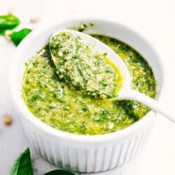 pesto sauce in a white bowl with a spoon