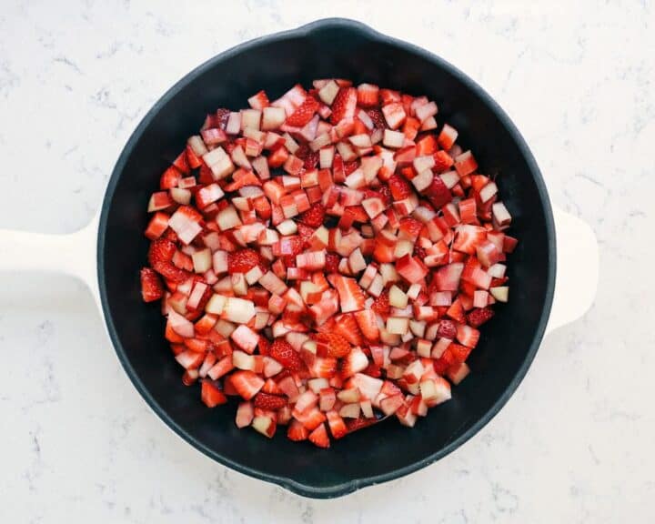 fresh chopped strawberries and rhubarb in cast iron skillet 