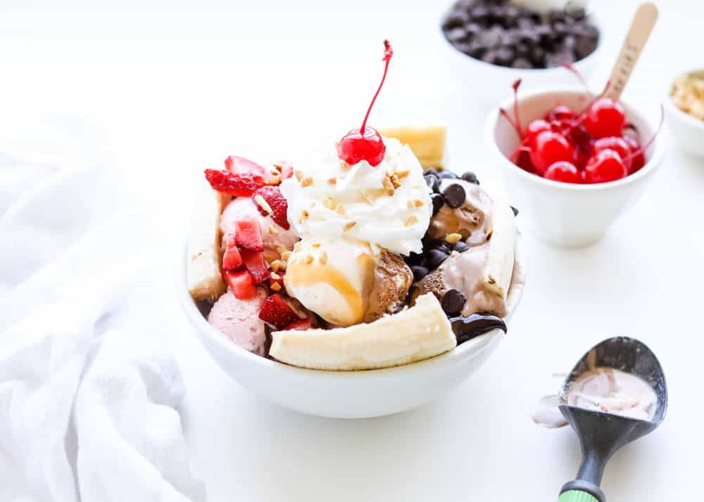 Banana split in a white bowl.