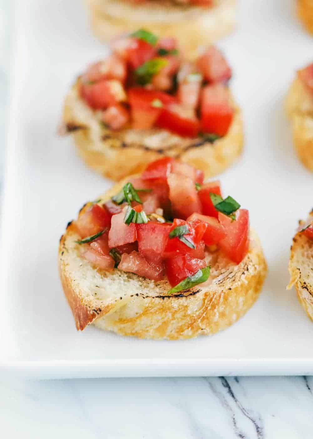 Toasted baguette topped with bruschetta.