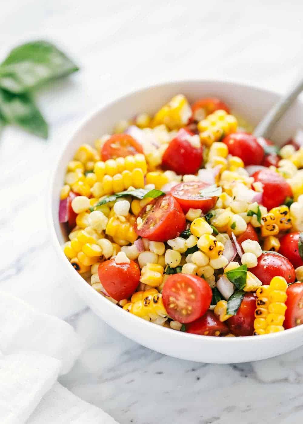 Corn salad recipe in a white bowl. 