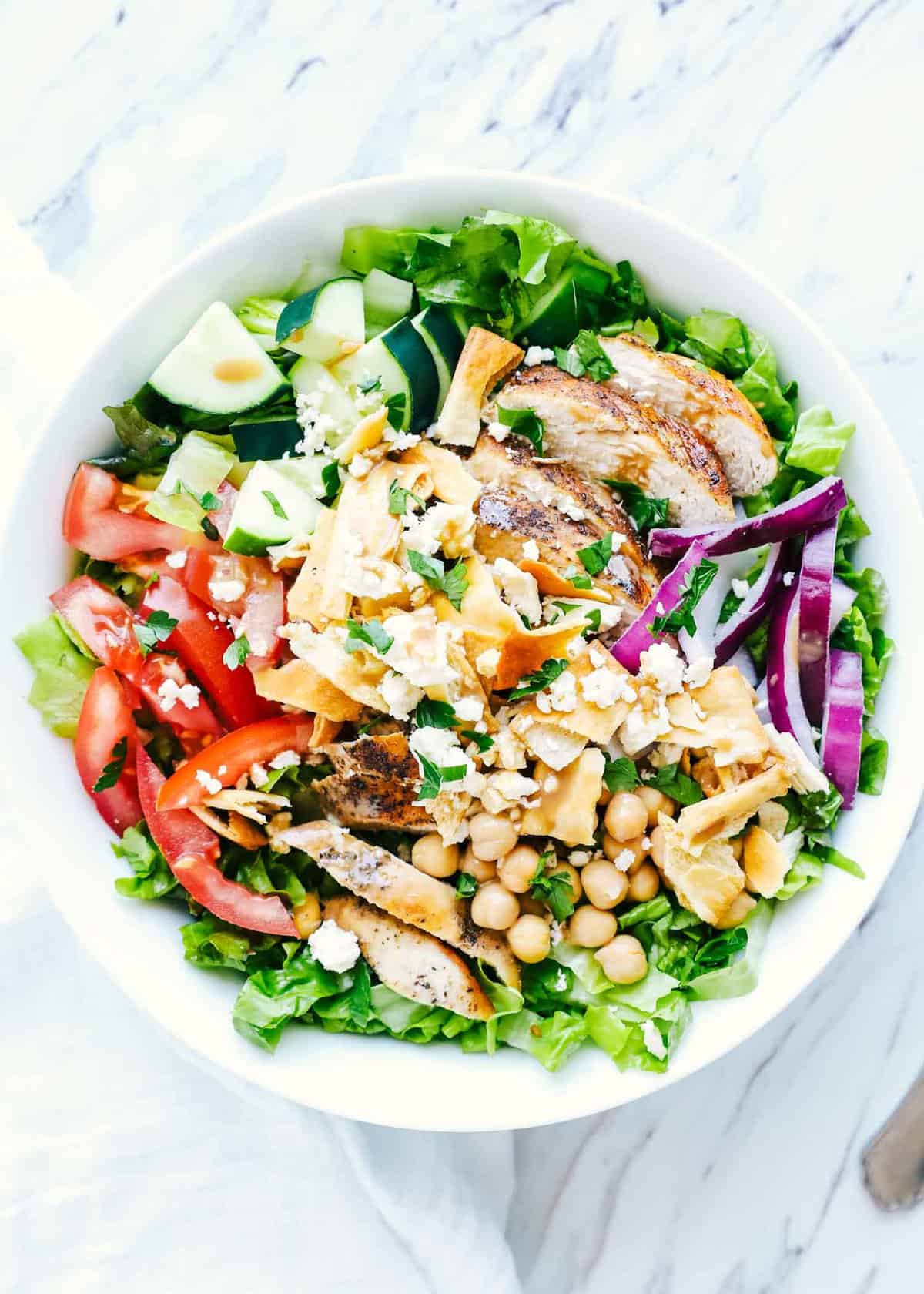 Mediterranean salad in a white bowl.