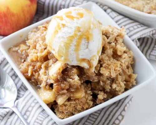 apple crisp with ice cream in white bowl