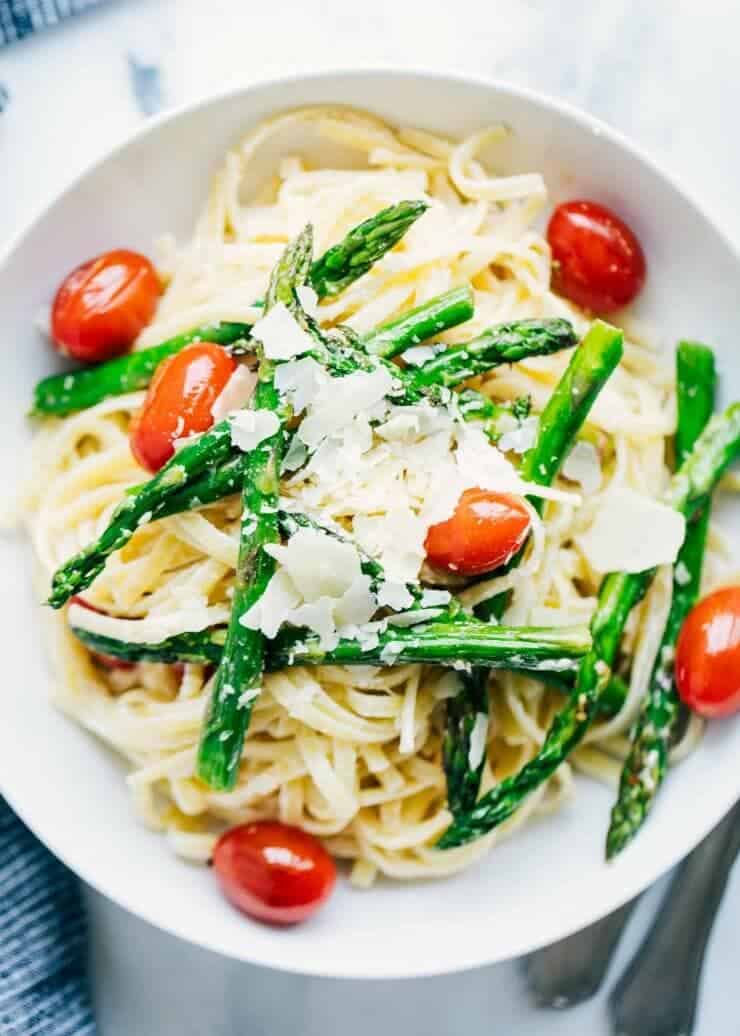 bowl of asparagus pasta with shaved parmesan on top 