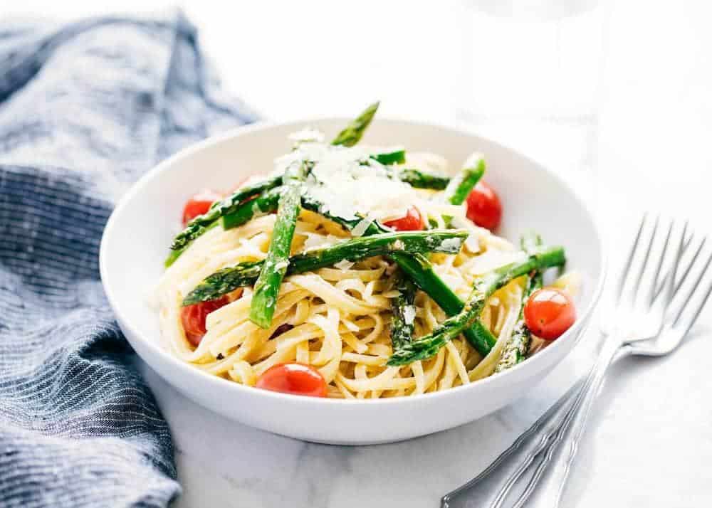 Asparagus pasta in a white bowl.
