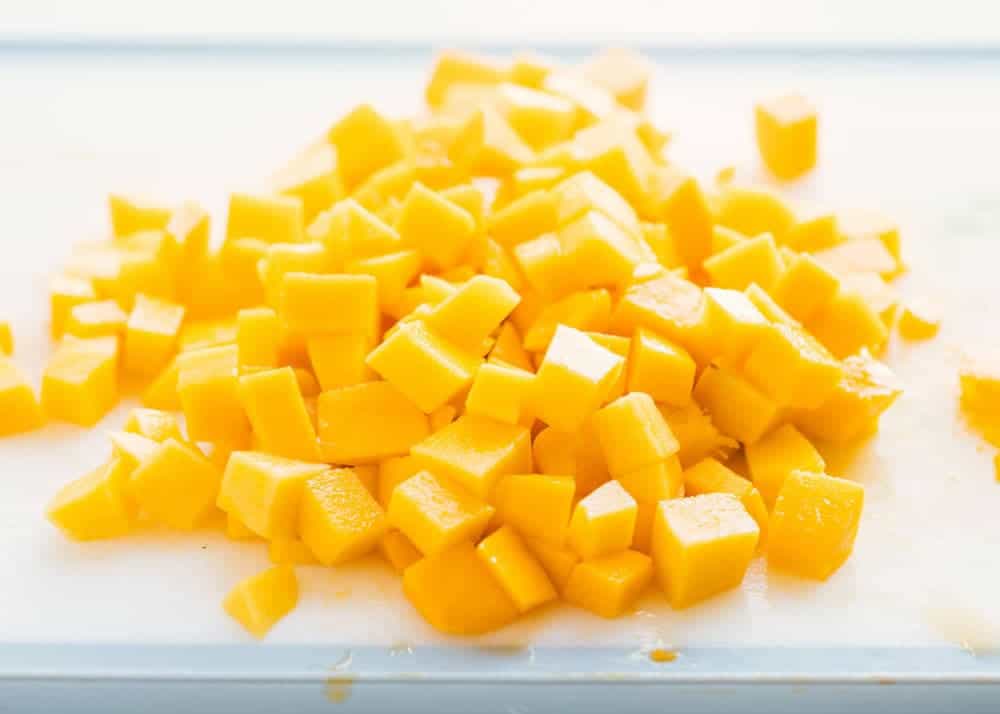 diced mango on a cutting board 