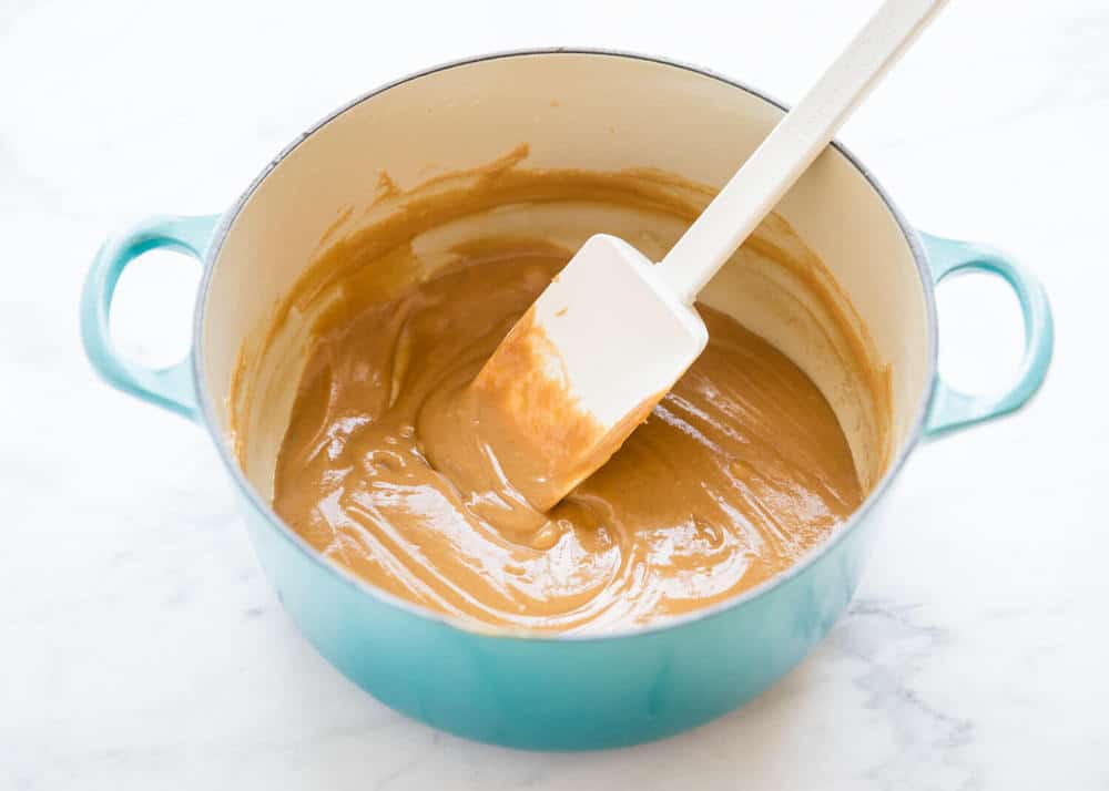 stirring peanut butter mixture in a large pot 