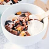 bowl of homemade ice cream with chopped Reese's and hot fudge