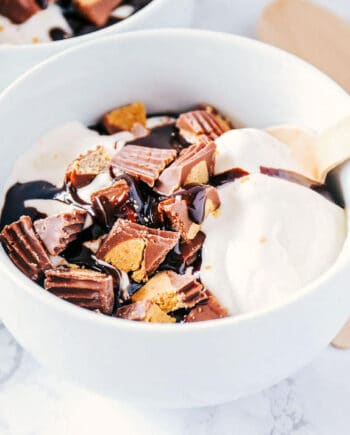 bowl of homemade ice cream with chopped Reese's and hot fudge