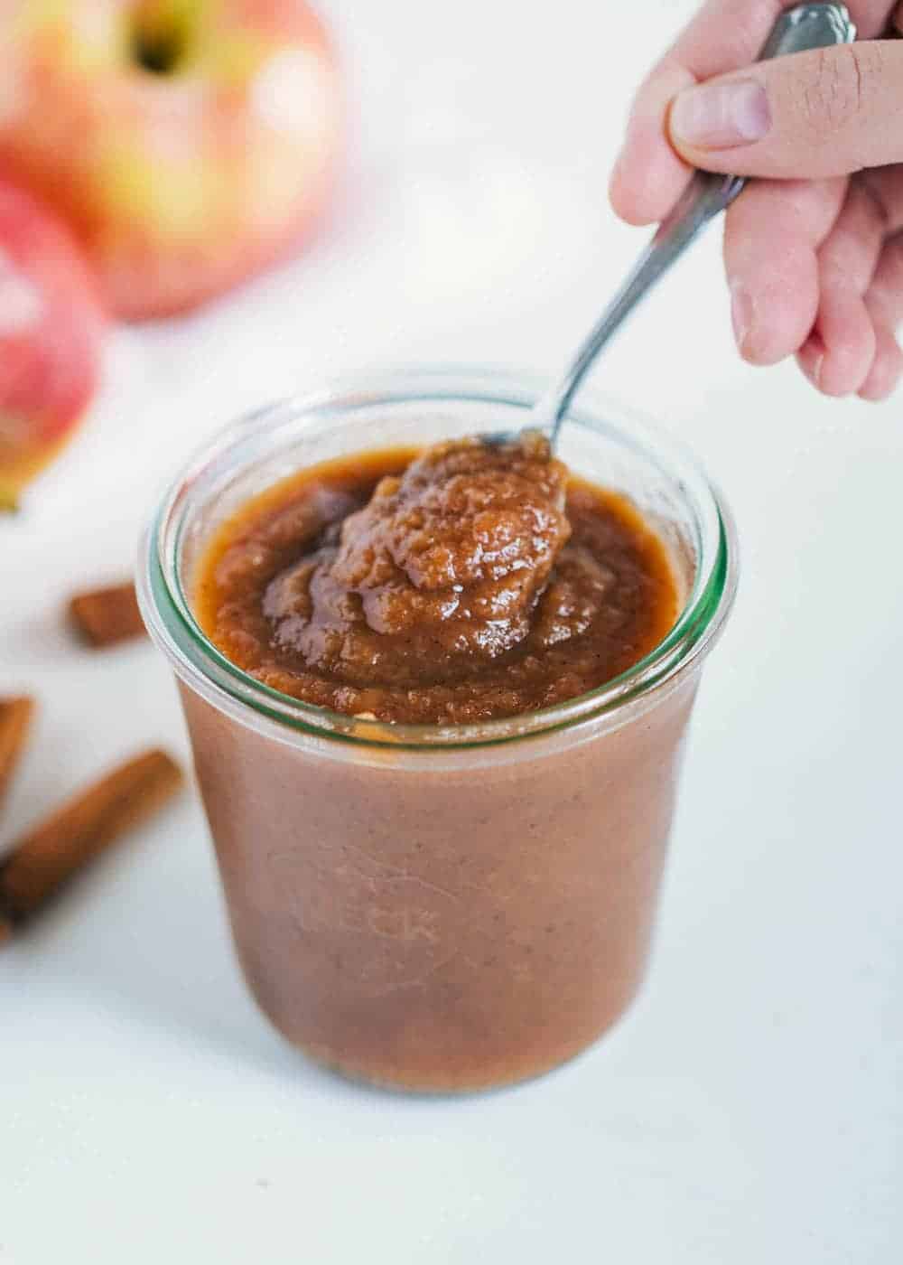 Apple butter in jar with spoon.