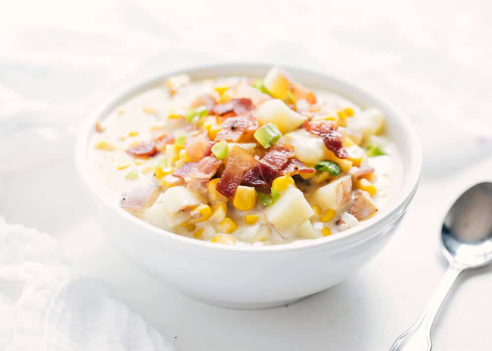 A comforting and delicious corn chowder soup packed with corn, potatoes and bacon. Full of flavor and simple to make. This is the perfect recipe for the fall or winter! Bowl of corn chowder.